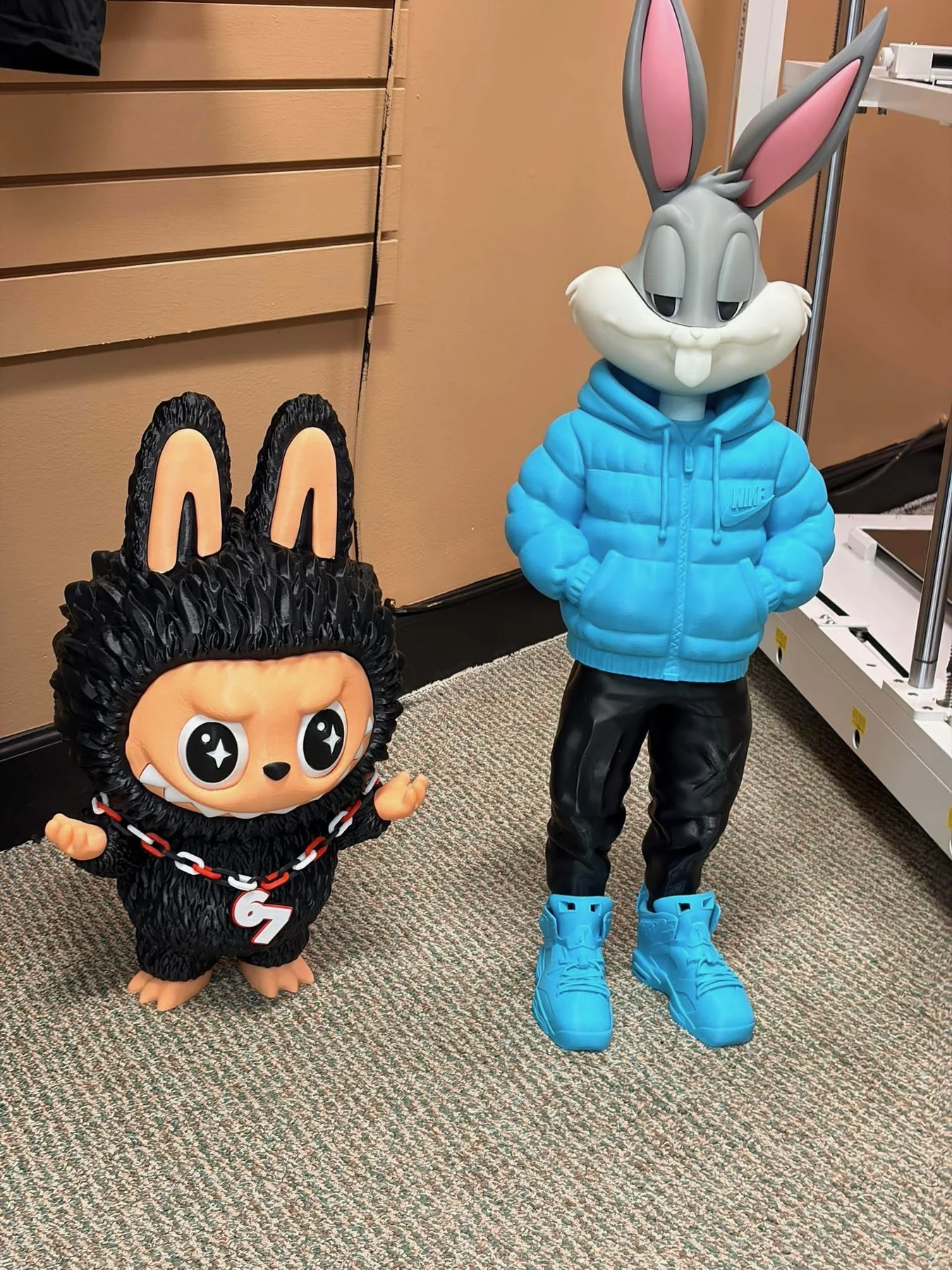Two large custom character figures displayed in the shop.