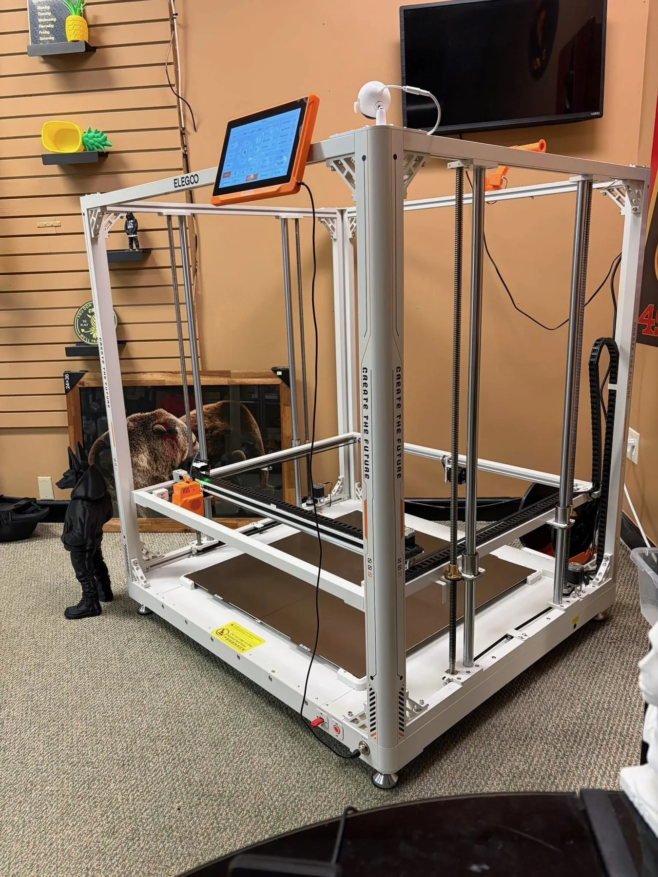 Large-format 3D printer inside the 3D Prints and More workspace.