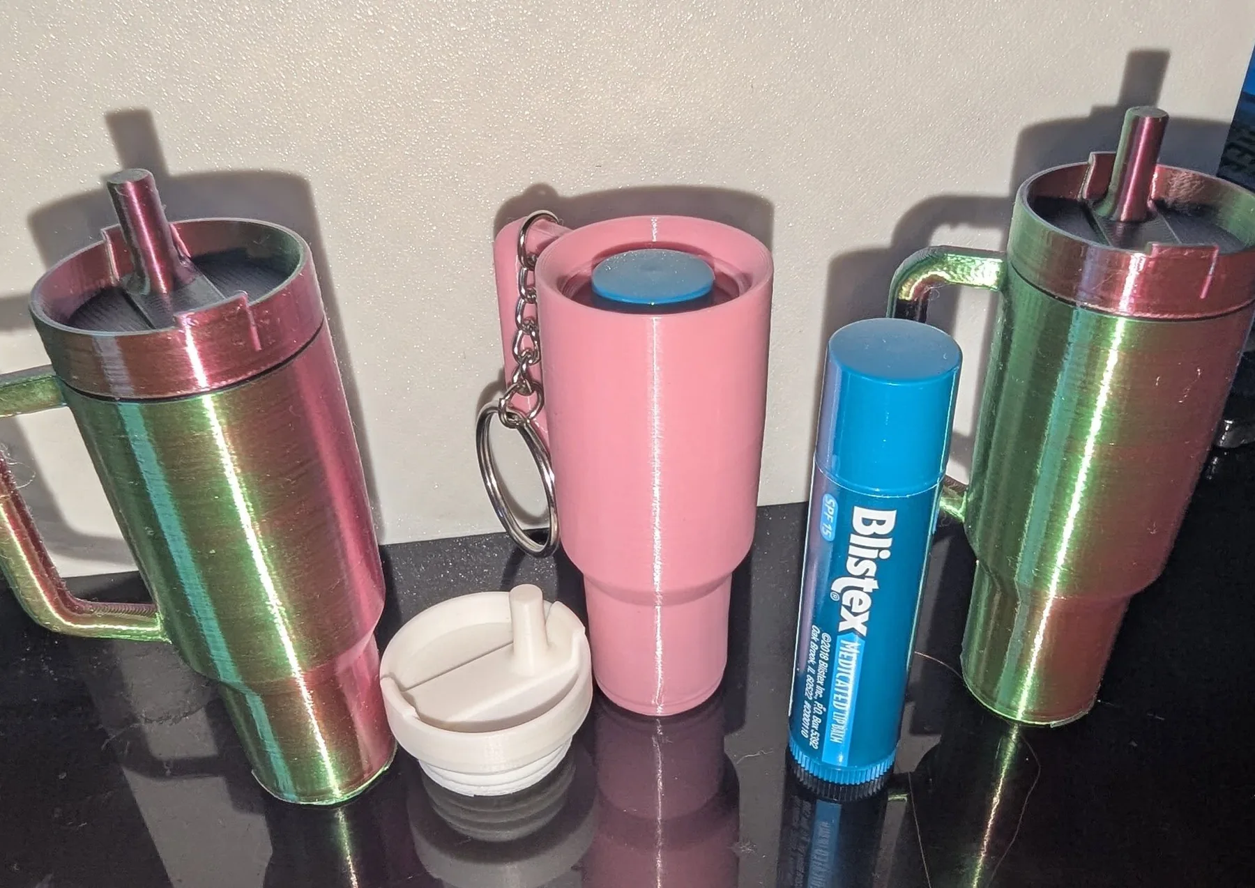 Personalized shimmer-finish tumblers, 3D printed and customized with names.