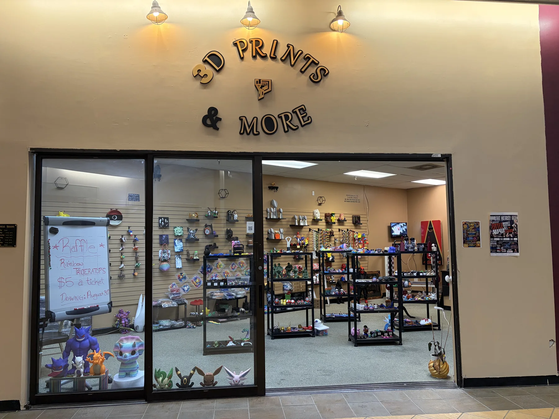 Updated storefront of 3D Prints and More at the Fingerlakes Mall, with character figures displayed in the window.