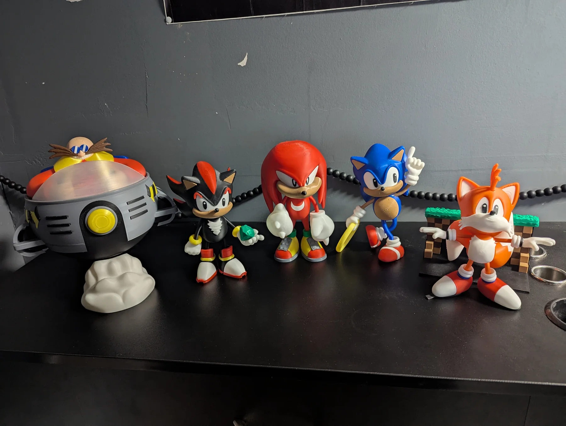 3D-printed video game character figures displayed in a row.